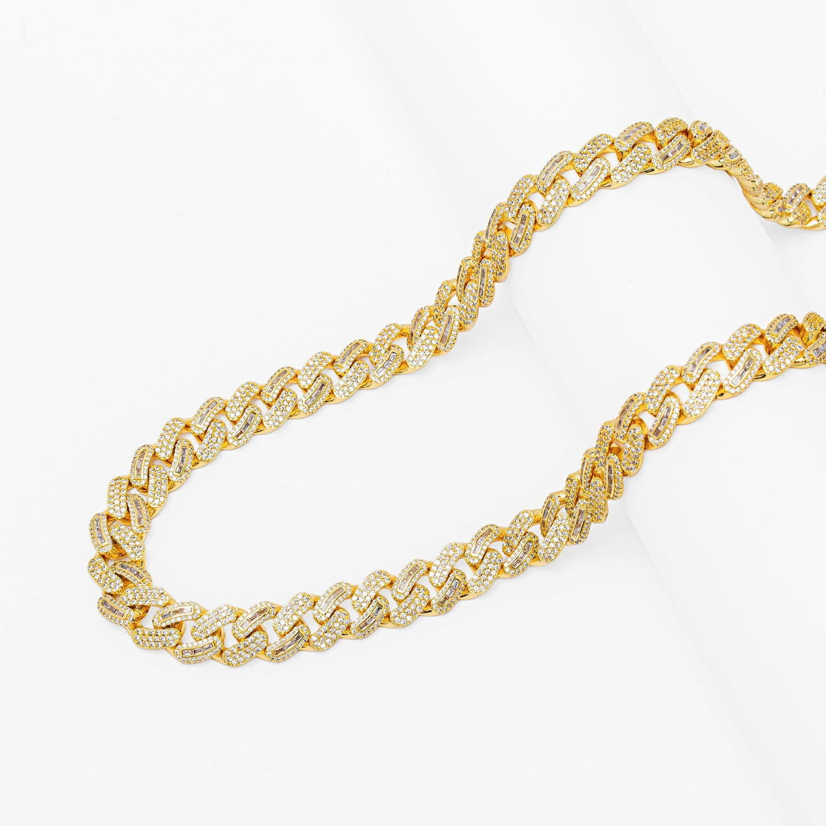 Two gold Cuban link chains showing 10mm baguette iced-out design