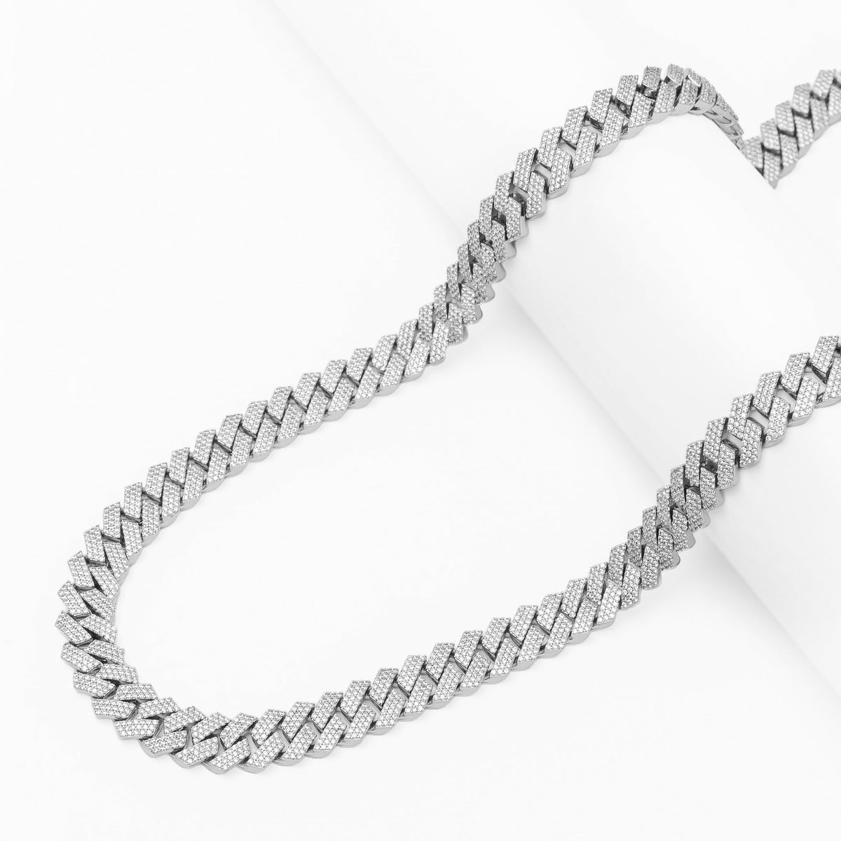 Side profile of iced out 10MM Cuban silver chain with diamond settings