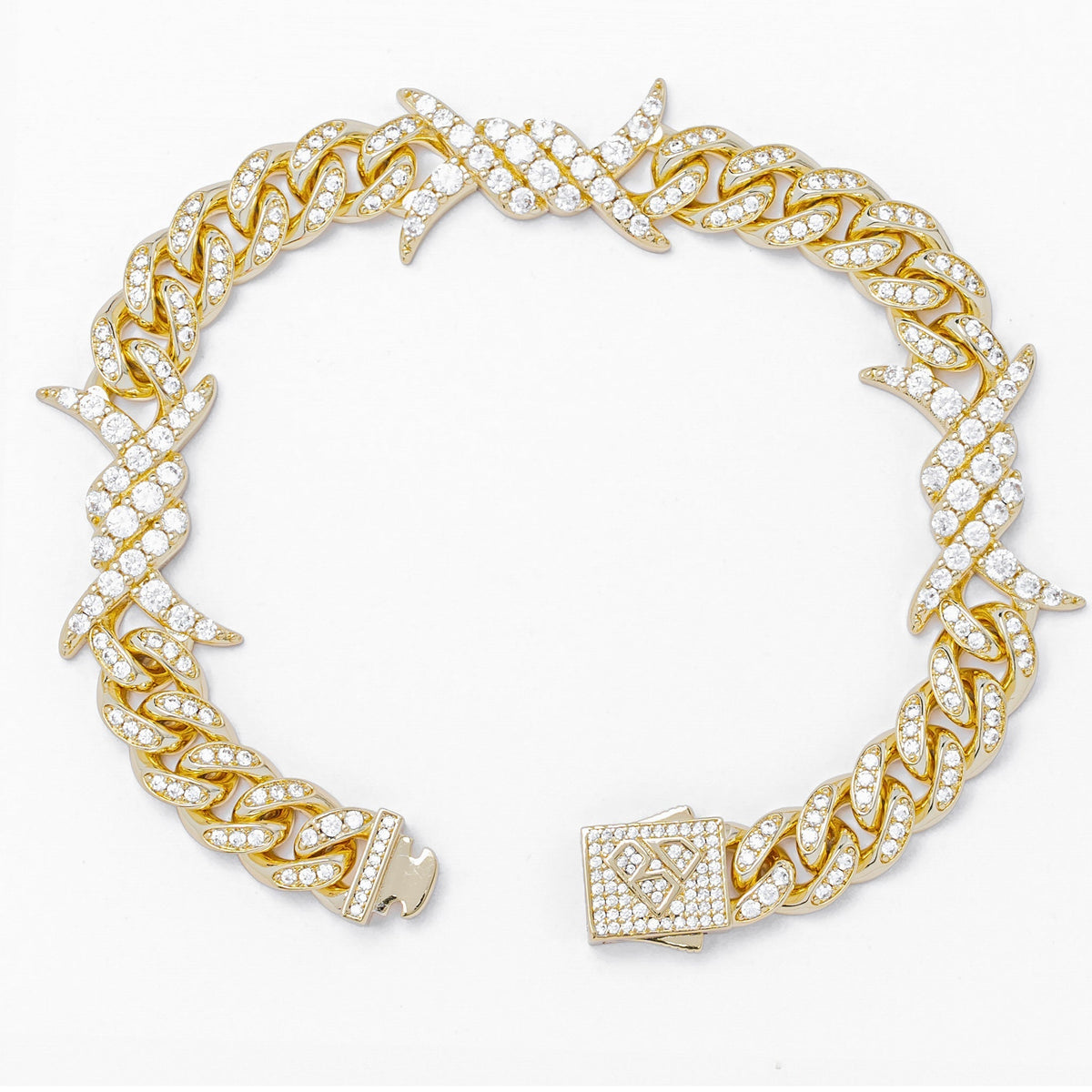 Gold spiked horns bracelet with iced-out cubic zirconia, angled side view showing clasp
