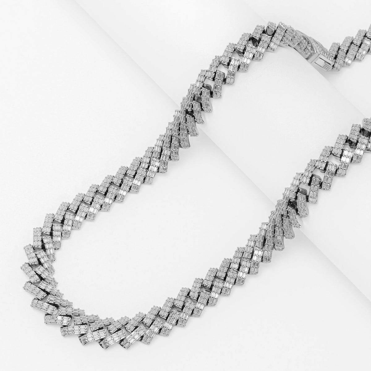 Big Daddy 12MM baguette Cuban diamond silver chain laid flat on white surface
