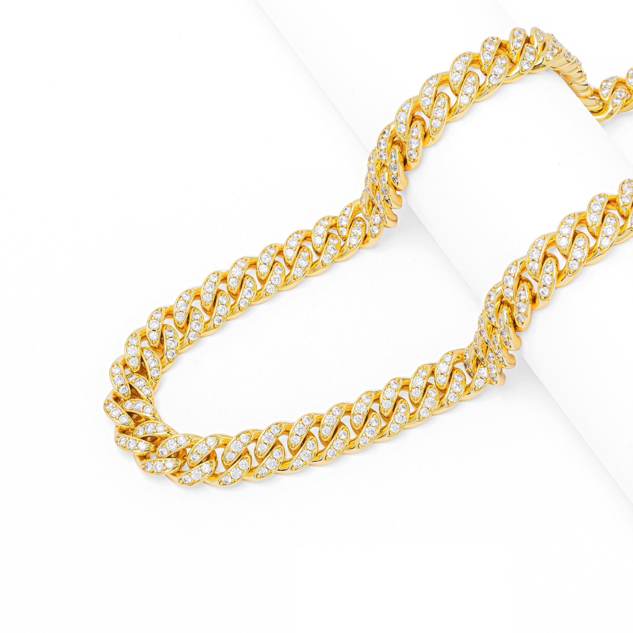 Gold Cuban link chain with iced out cubic zirconia stones angled view