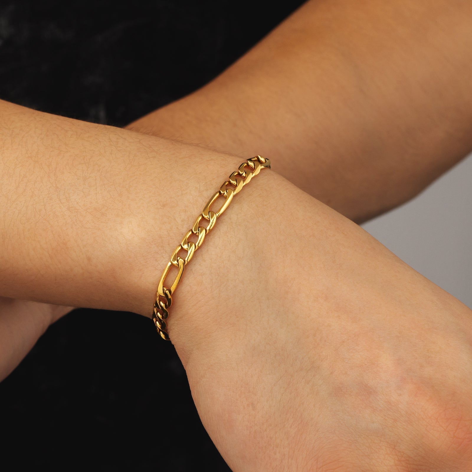 6mm steel Figaro gold bracelet worn on wrist showing fit and appearance