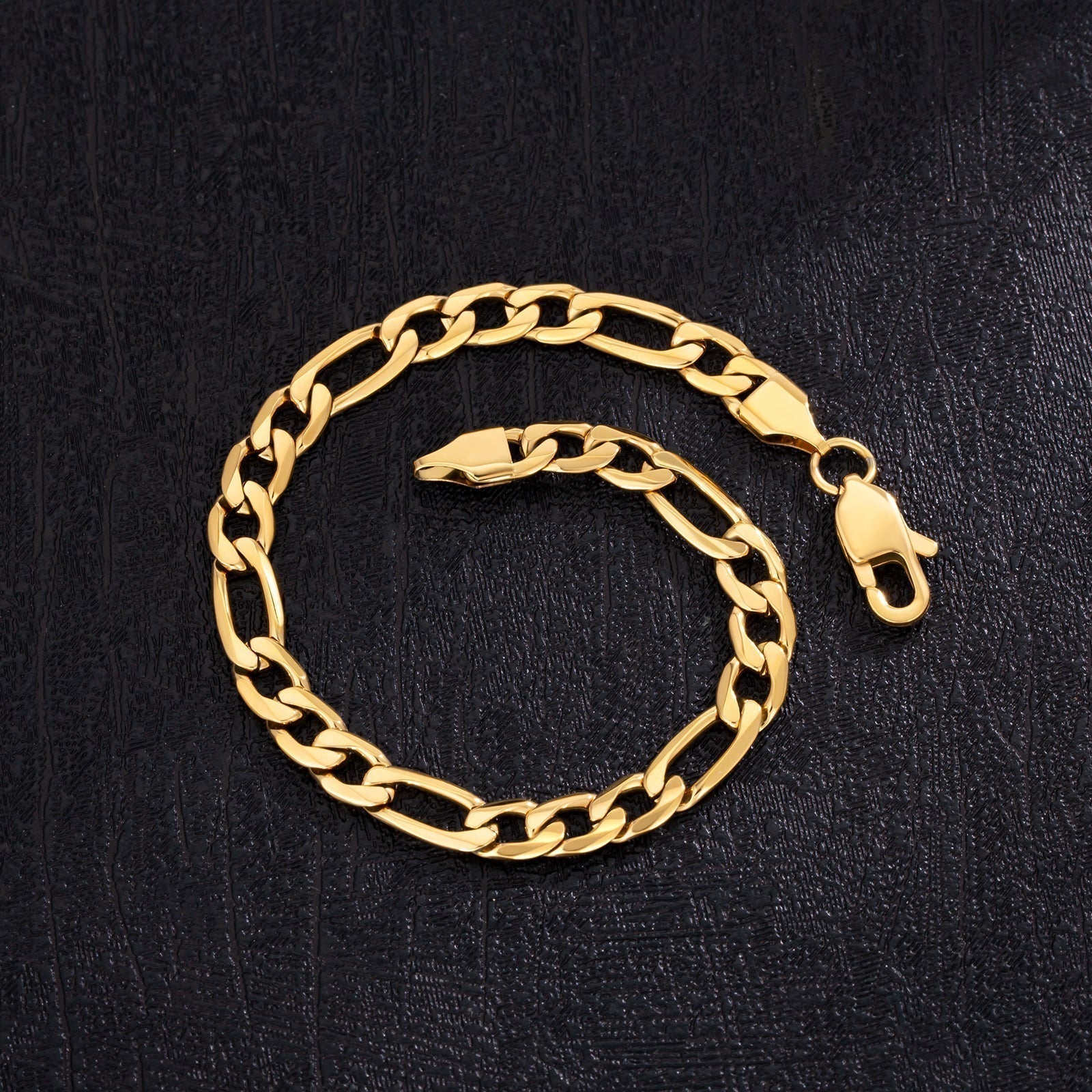 6mm steel Figaro gold bracelet display showing lobster clasp and chain links