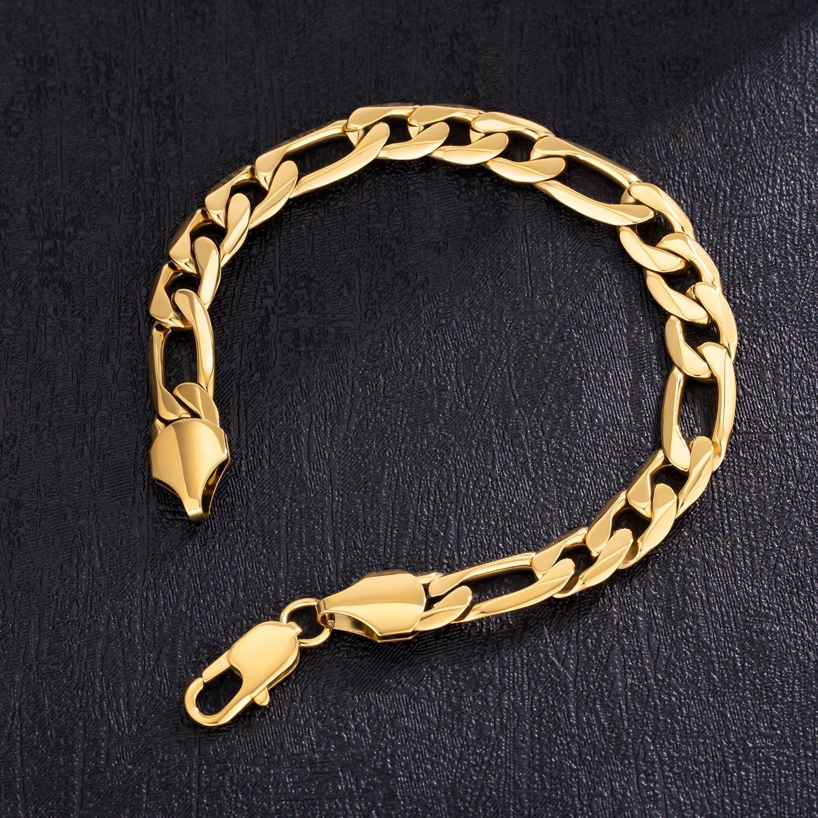 Big Daddy 9mm gold figaro bracelet displayed on dark background showing chain links and clasp