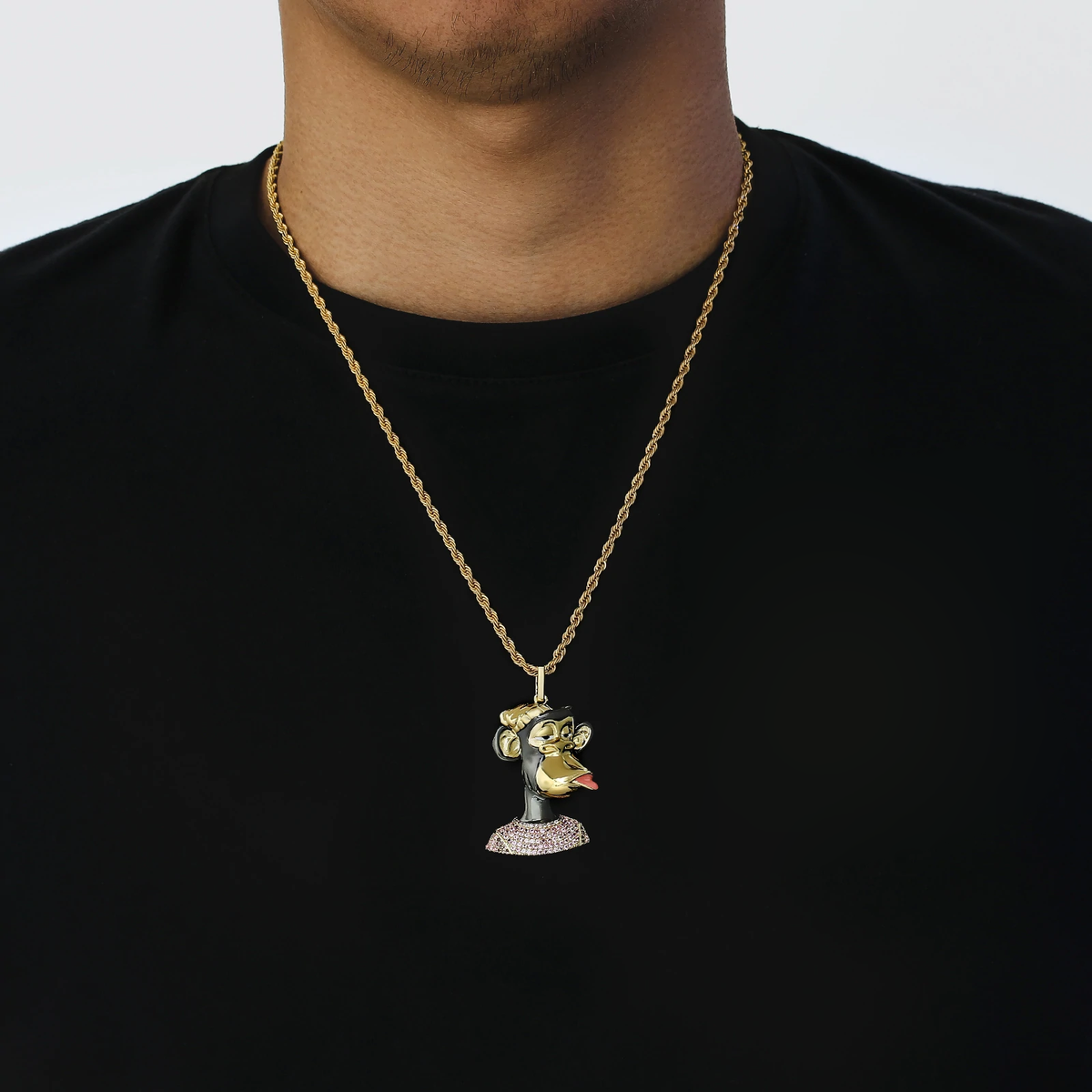 Iced out Bored Ape pendant worn on gold chain around neck on black shirt