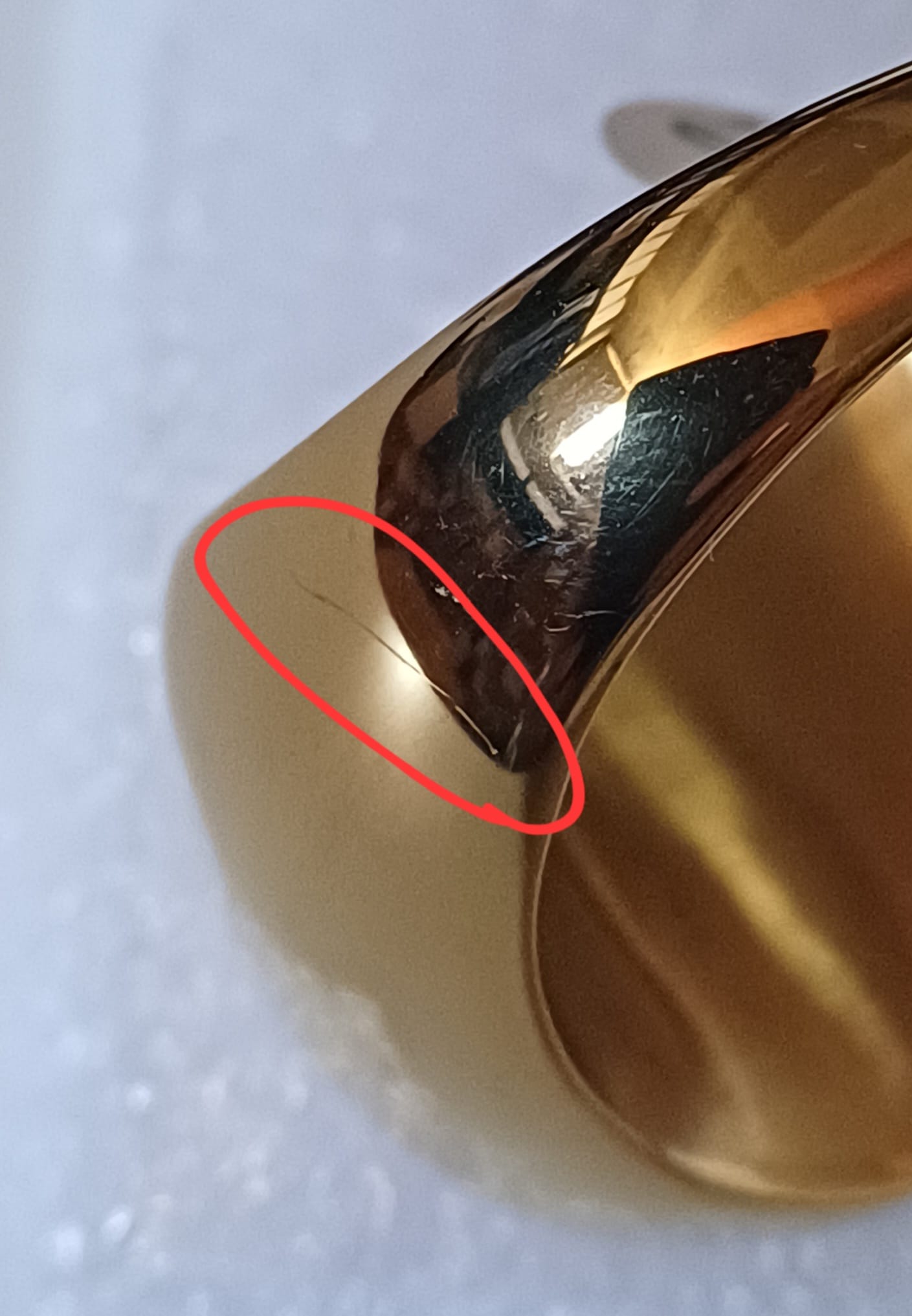 Ring detail showing defect area circled in red on polished surface