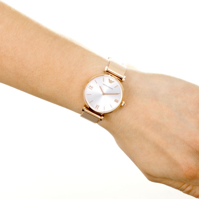 Emporio Armani AR1956 rose gold-tone watch on wrist with silver dial and Roman numerals