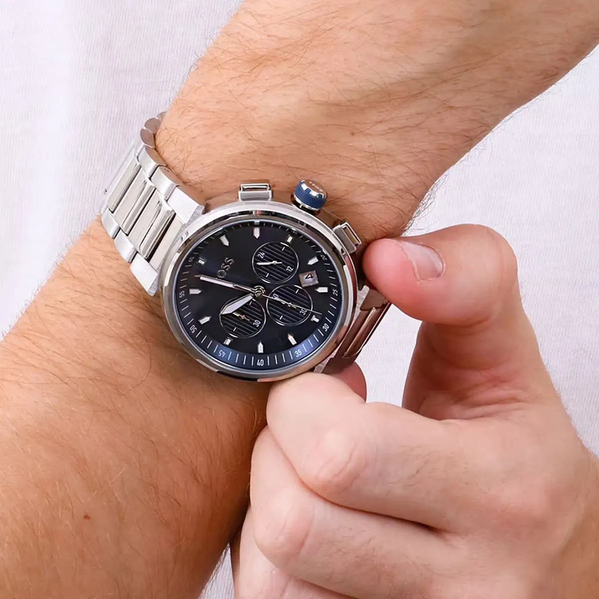Hugo Boss One chronograph watch worn on wrist, displaying blue dial and silver steel bracelet