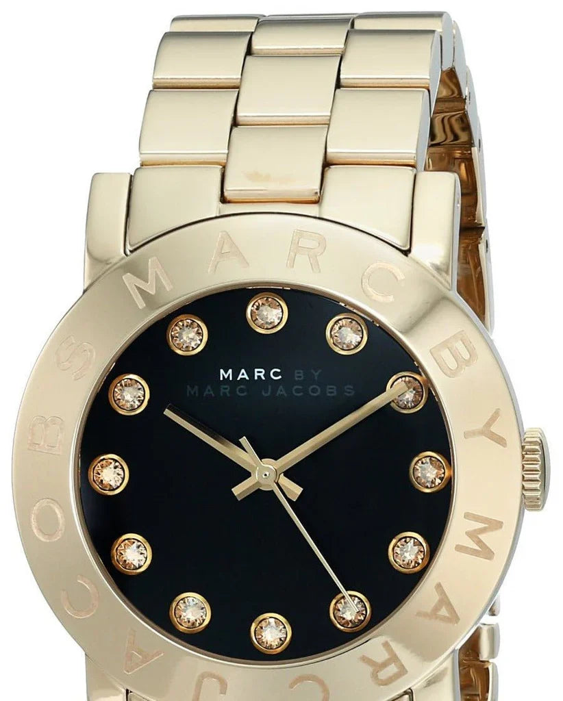Black dial with crystal hour markers and gold-tone steel bezel with MARC BY MARC JACOBS text
