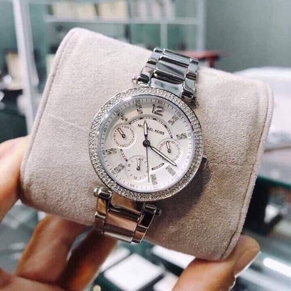 Michael Kors Parker MK5615 watch displayed on beige fabric wrist rest