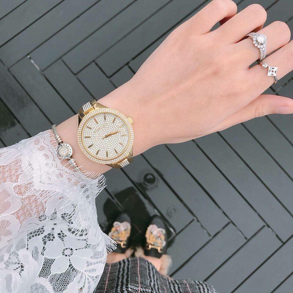 Michael Kors Slim Runway gold-tone watch worn on wrist with crystal-embellished dial