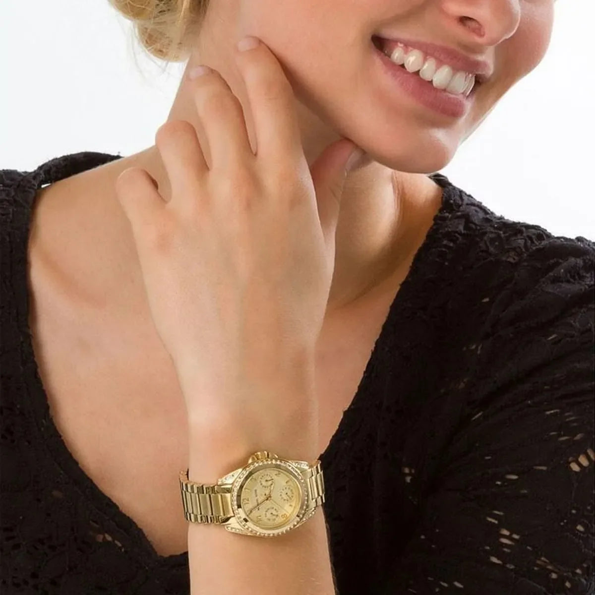 Michael Kors Blair gold-tone women's watch worn on wrist with champagne dial and crystal bezel