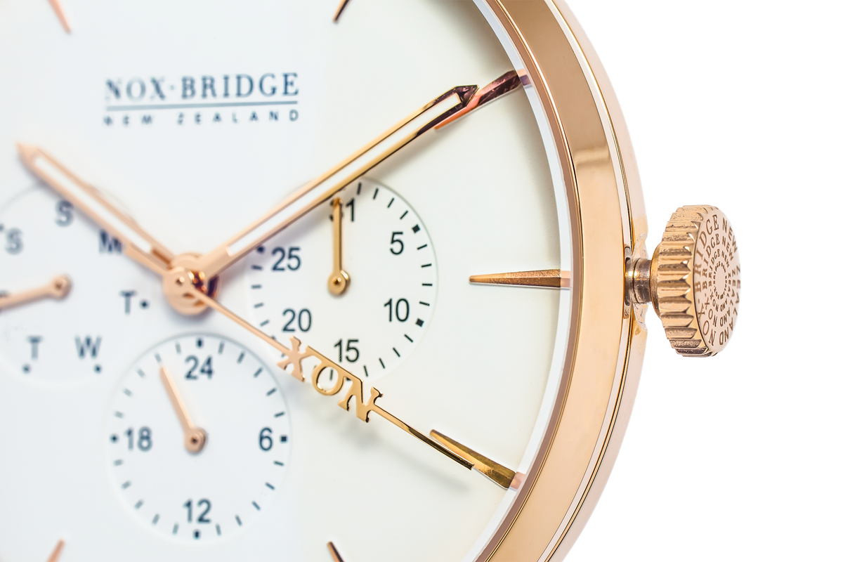 Close-up of rose gold case, cream dial with dual subdials, and crown detail