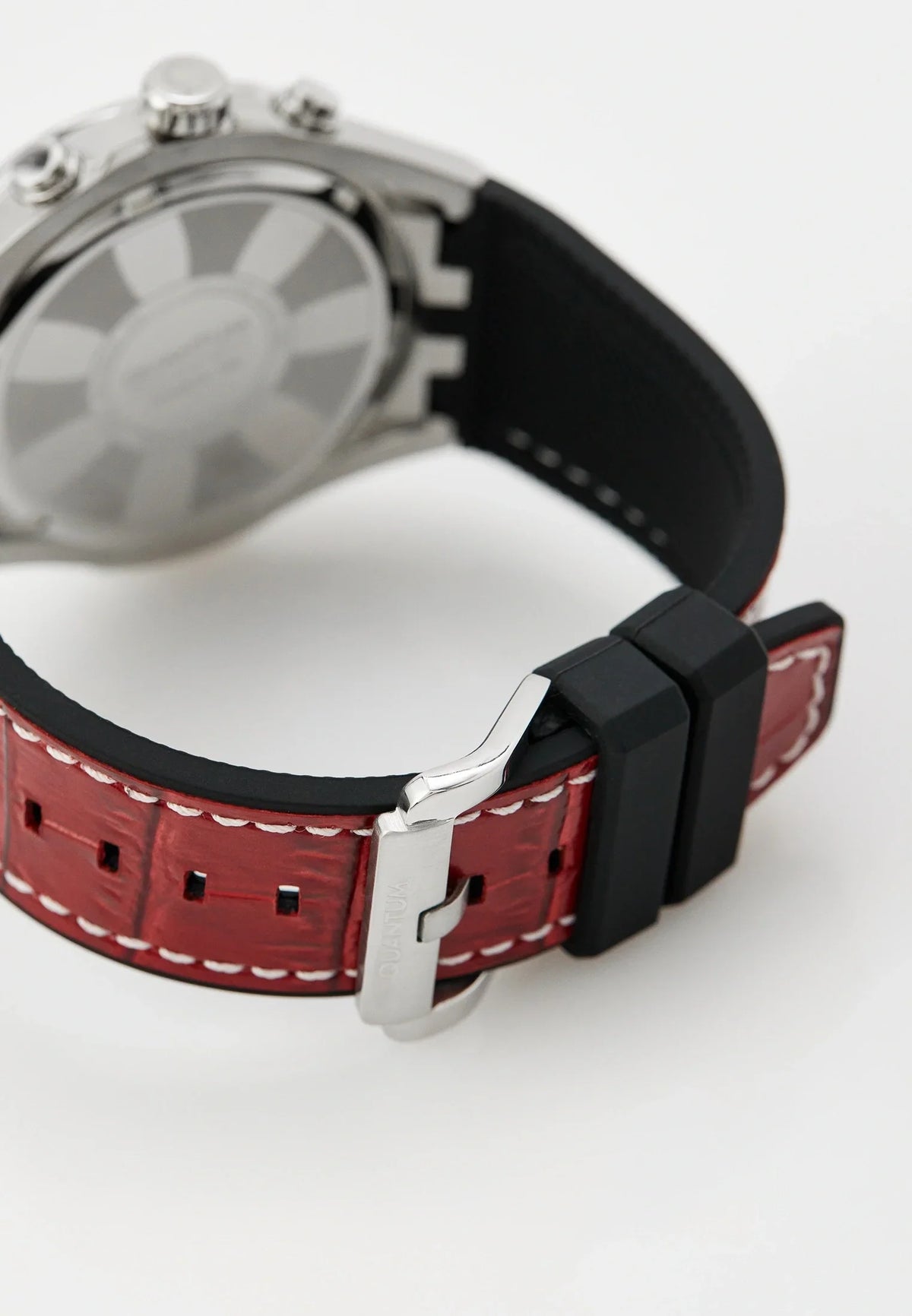 Quantum watch worn on wrist showing gunmetal dial and red silicon strap