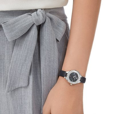 Swarovski Lovely Crystals Mini watch worn on wrist, styled with gray outfit