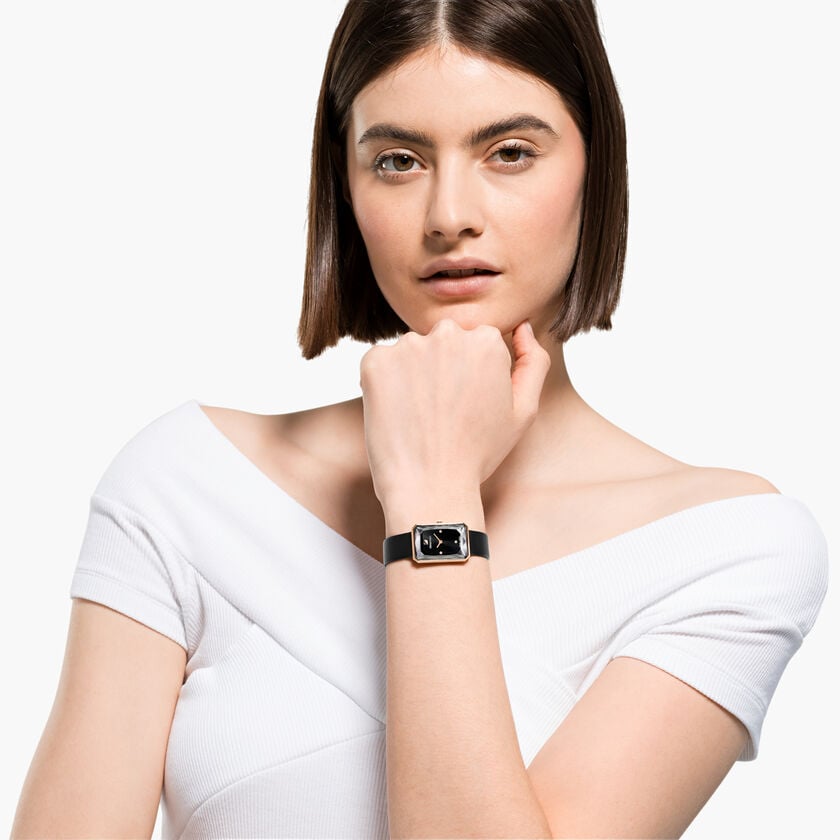 Swarovski Uptown watch worn on wrist, rectangular black dial with rose-gold case