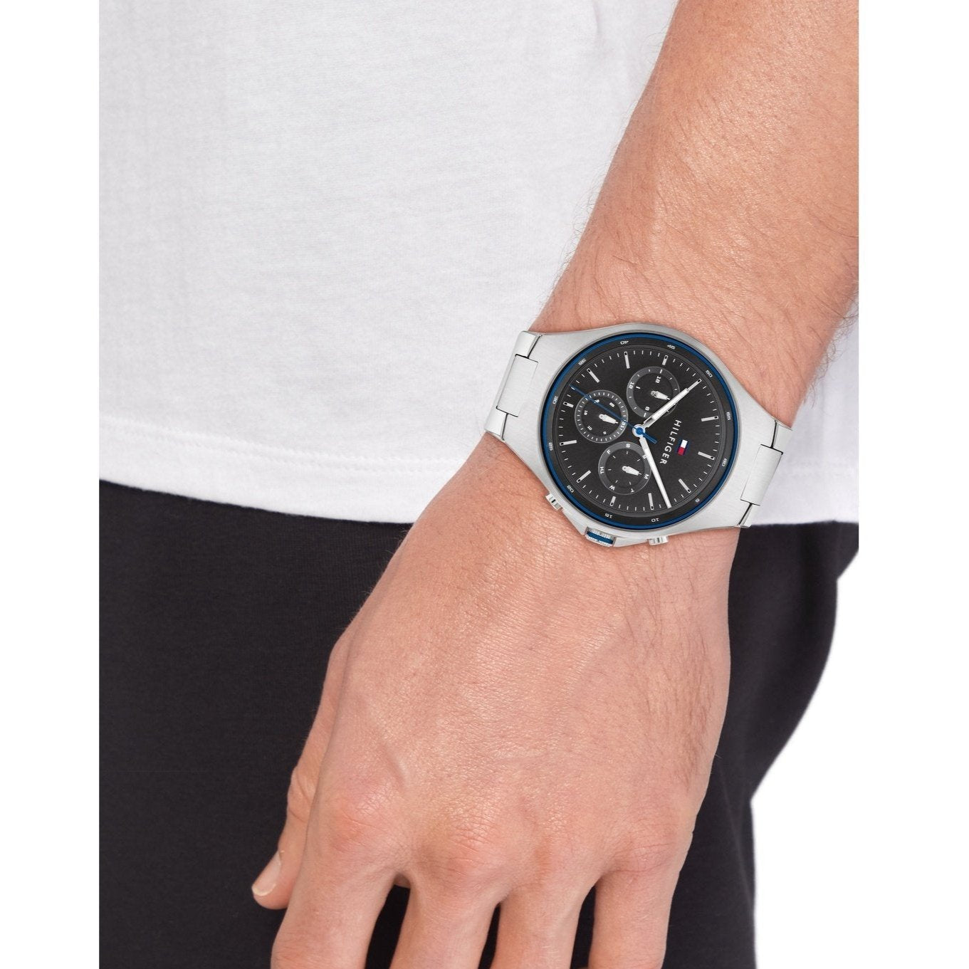Tommy Hilfiger 1792054 chronograph watch on wrist with silver band and black dial