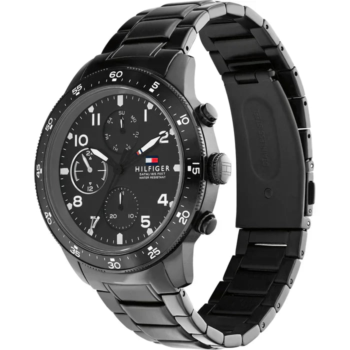 Tommy Hilfiger Jimmy watch at angle showing black chronograph dial and metal bracelet