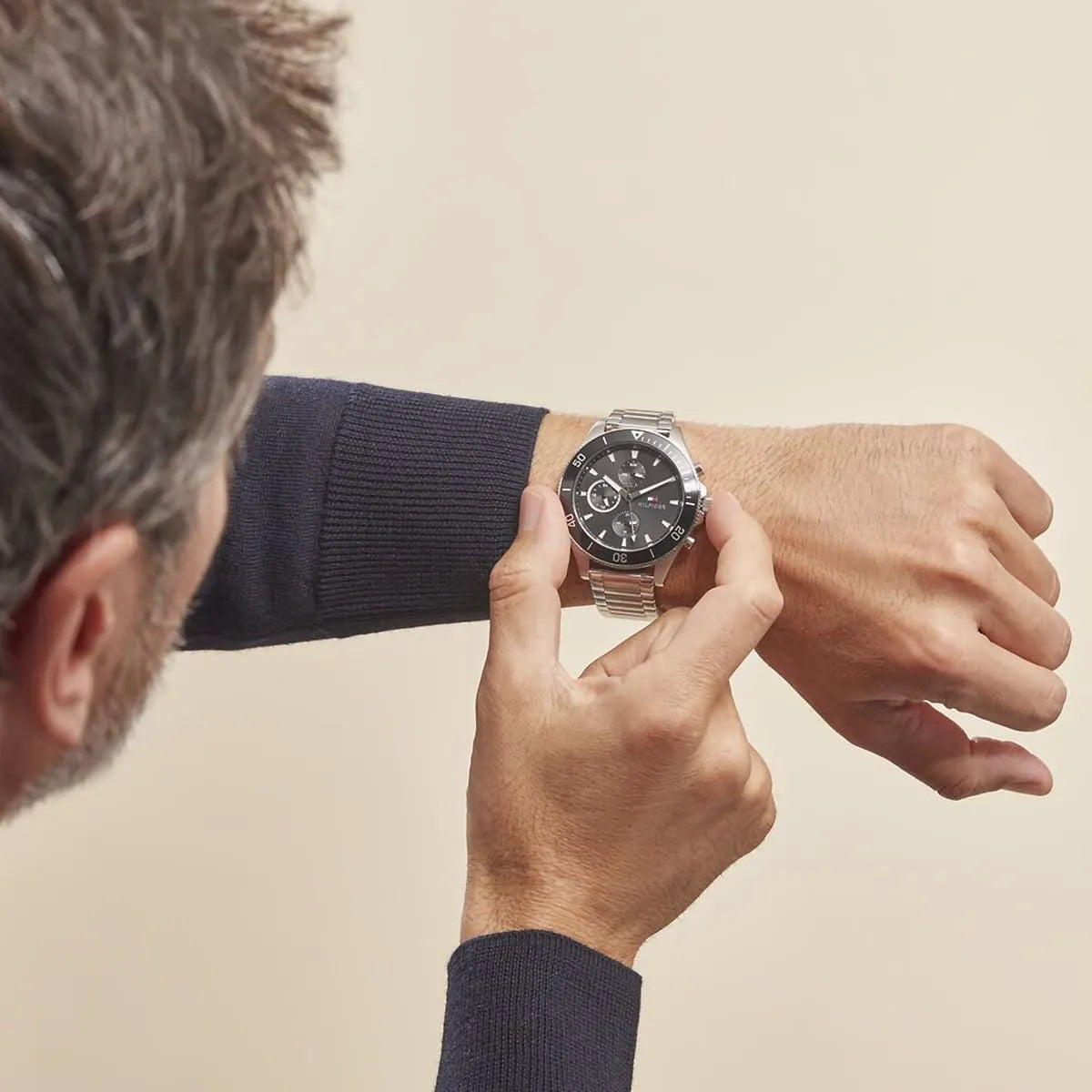 Tommy Hilfiger Larson watch worn on wrist, black dial with chronograph subdials