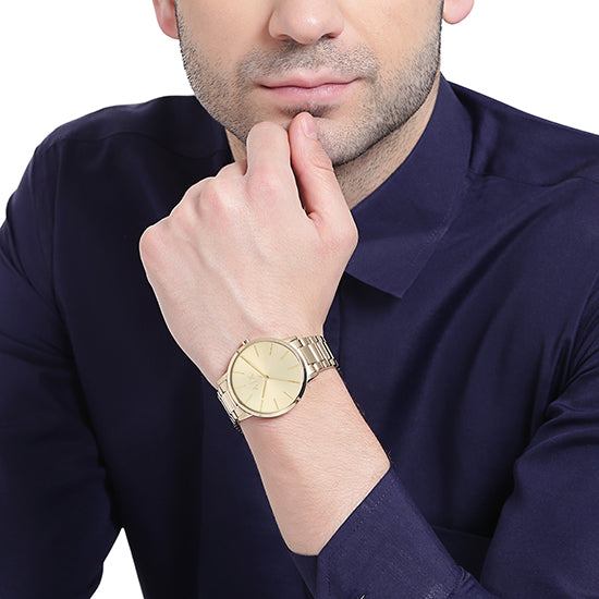 AX2707 three-hand watch on wrist showing minimalist dial and gold-tone design