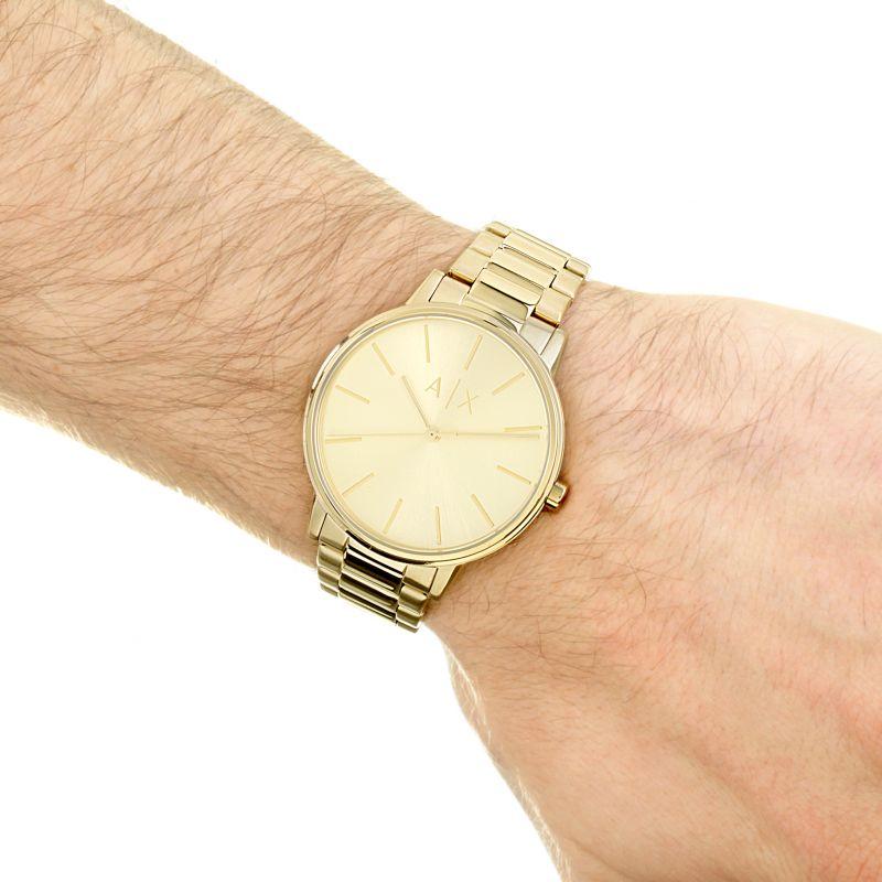 Armani Exchange AX2707 gold-tone watch worn on wrist