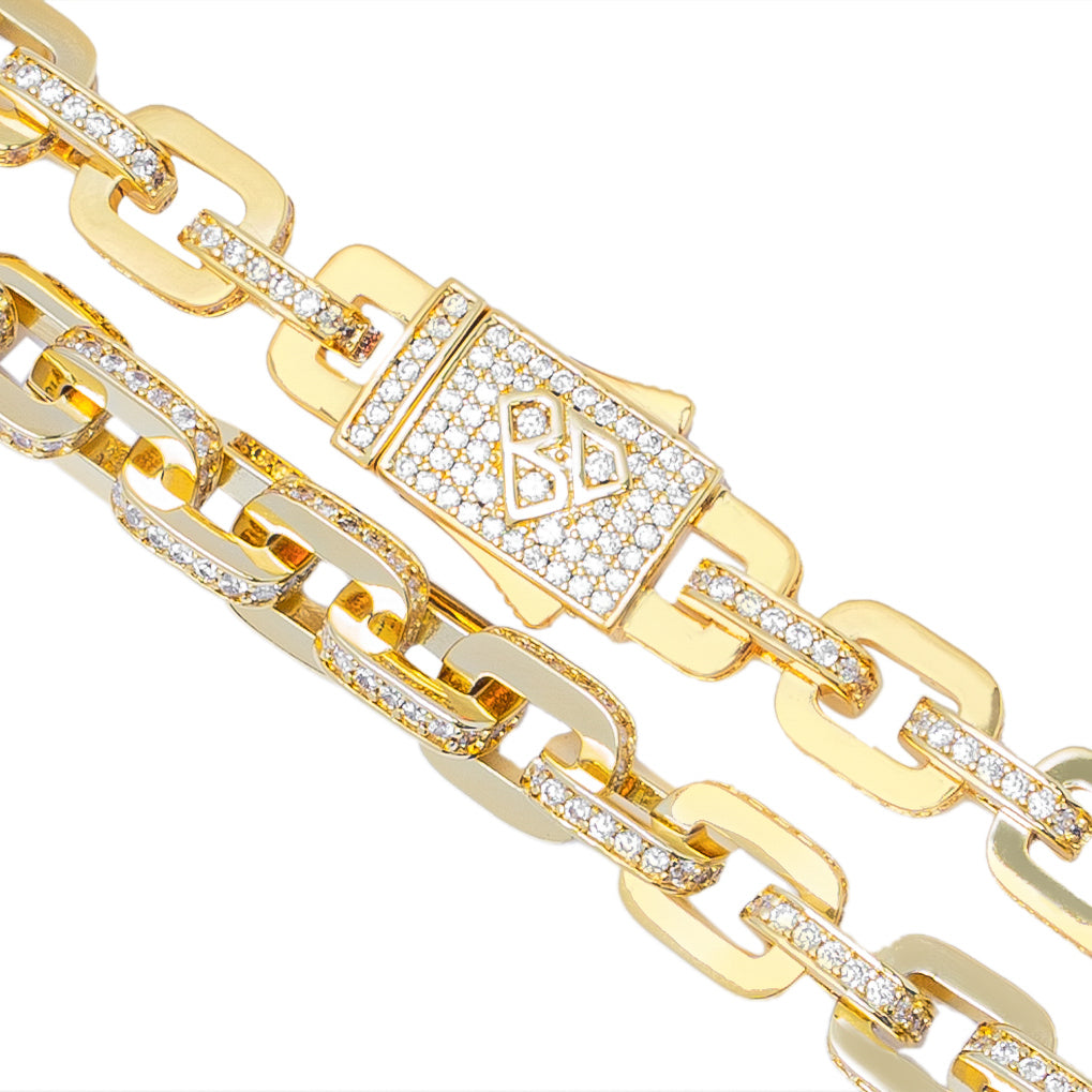 Close-up of Big Daddy gold chain links and diamond-set clasp detail