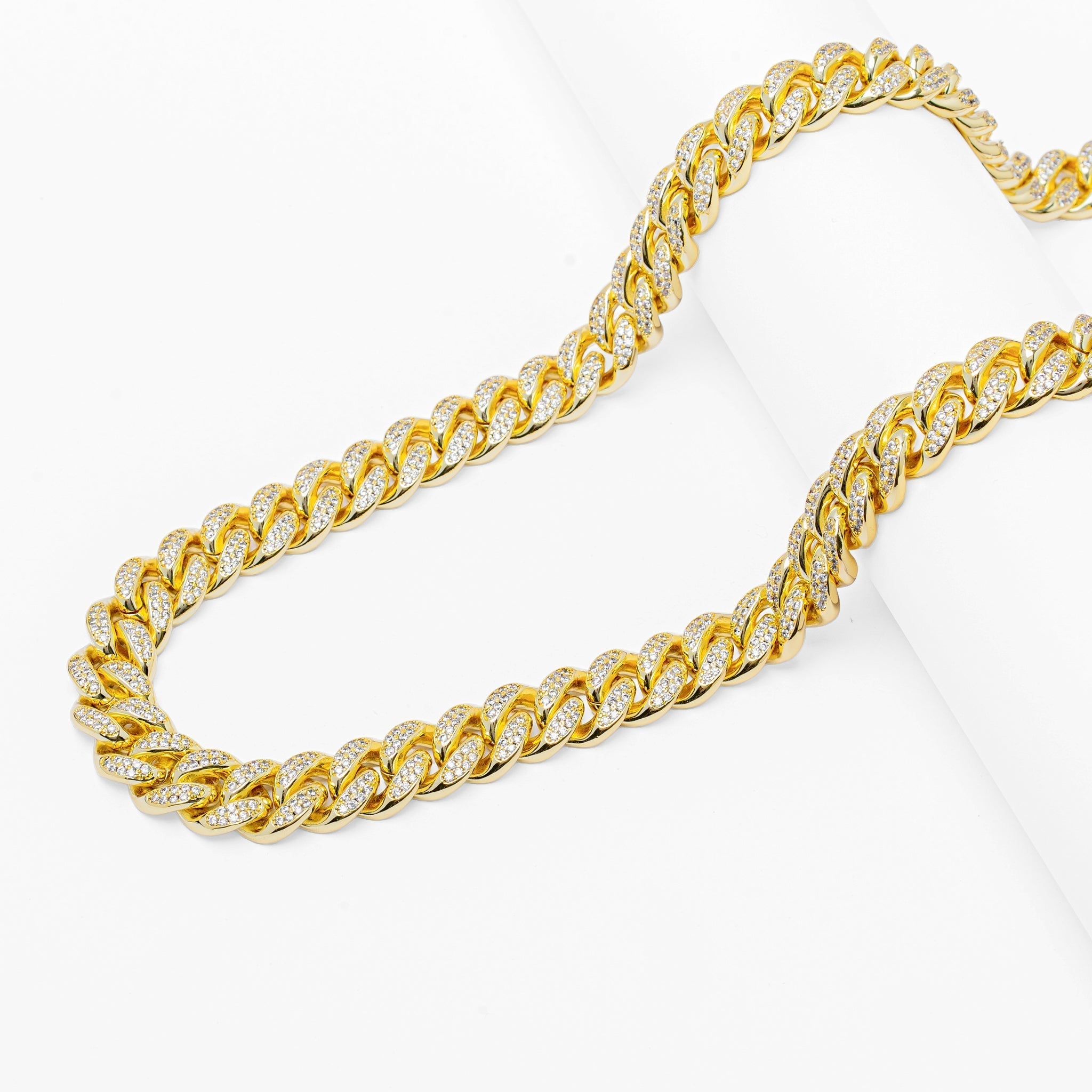 Full length view of 12MM gold Cuban link chain on white background