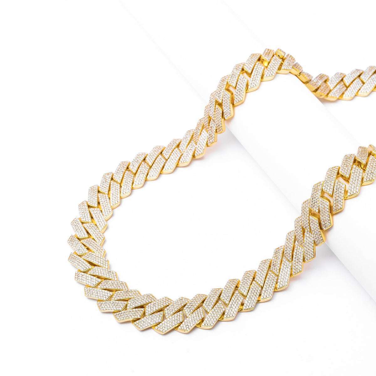 Gold Cuban link chain with diagonal view showing link pattern and stones