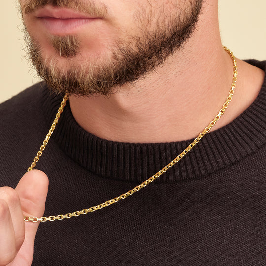 3mm gold mariner cable chain worn on man's neck with black ribbed sweater
