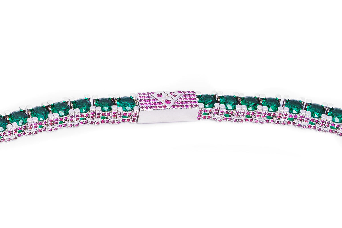Close-up of tennis chain clasp with green and ruby stone detail