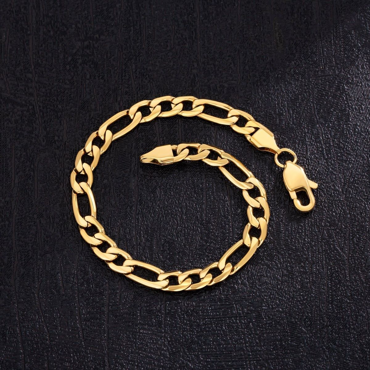 6mm steel Figaro gold bracelet display showing lobster clasp and chain links