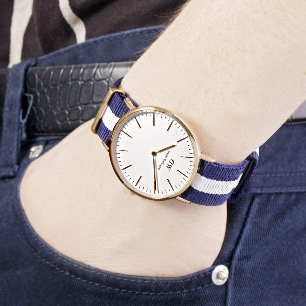 Daniel Wellington Glasgow 40mm rose gold watch worn on wrist with navy white striped NATO strap