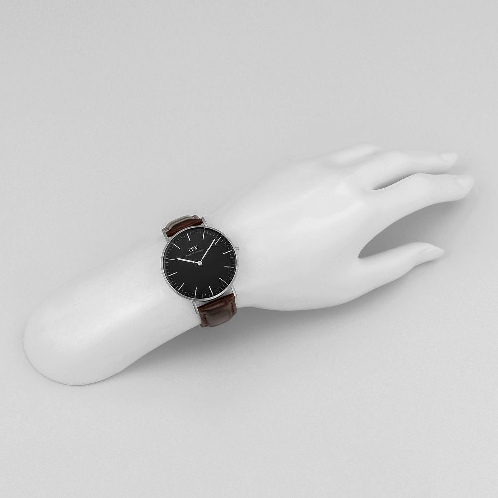 Daniel Wellington York 36mm watch worn on wrist showing black dial and brown strap