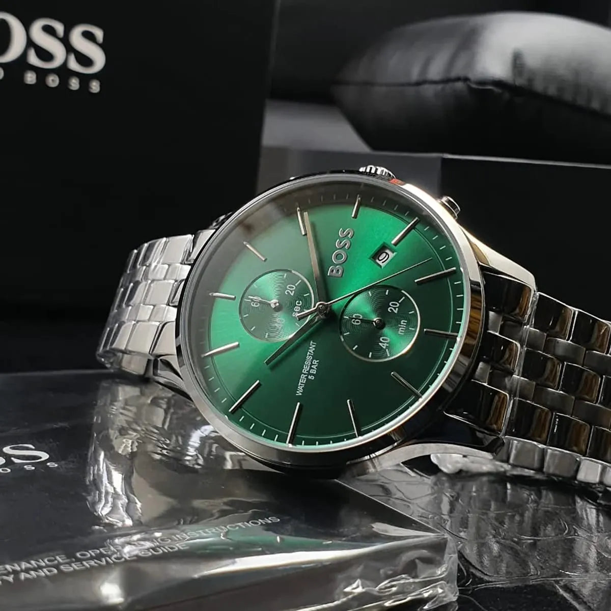 Hugo Boss Associate watch with green dial and silver bracelet displayed with brand packaging