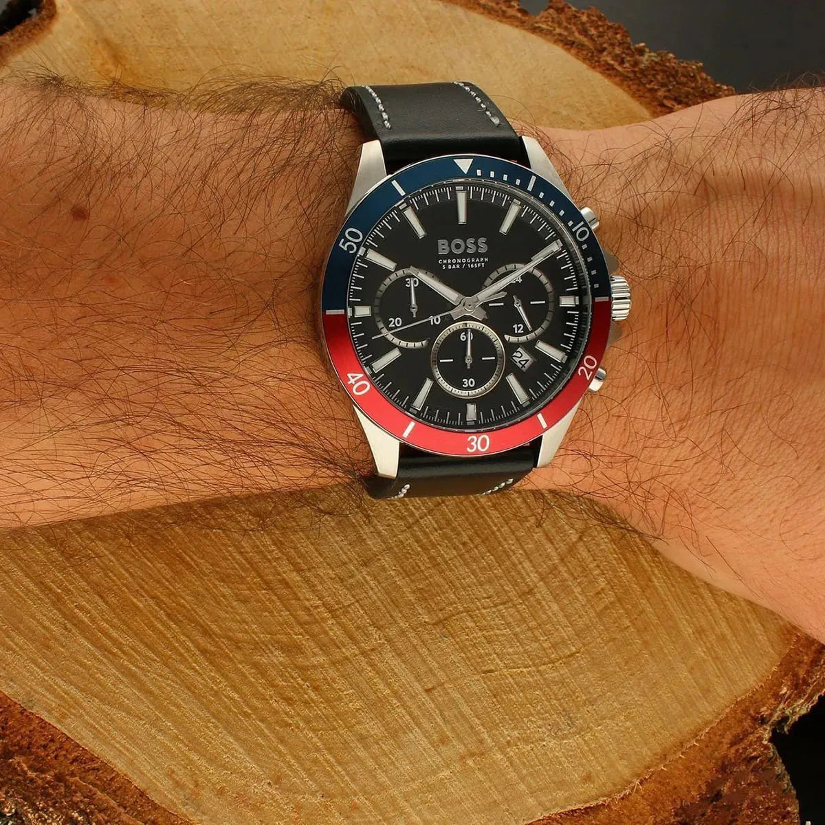 Hugo Boss Troper chronograph watch worn on wrist with black leather strap and blue-red bezel