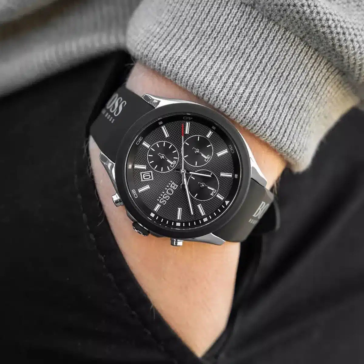 Hugo Boss Velocity chronograph watch worn on wrist with gray sweater and black jacket