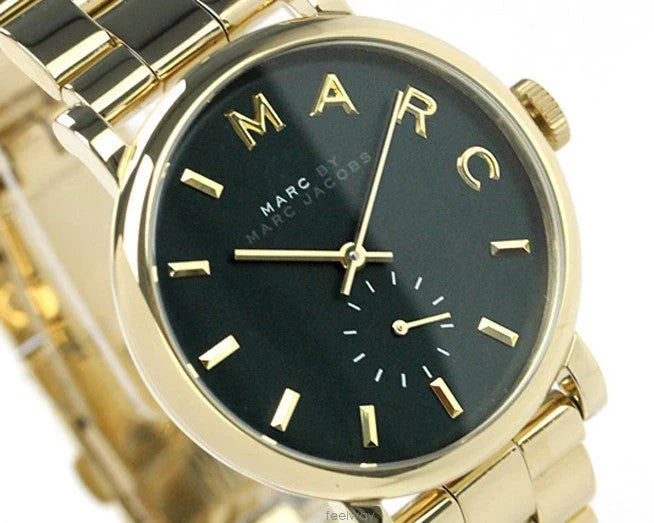 Close-up of green dial with gold hour markers and subdial