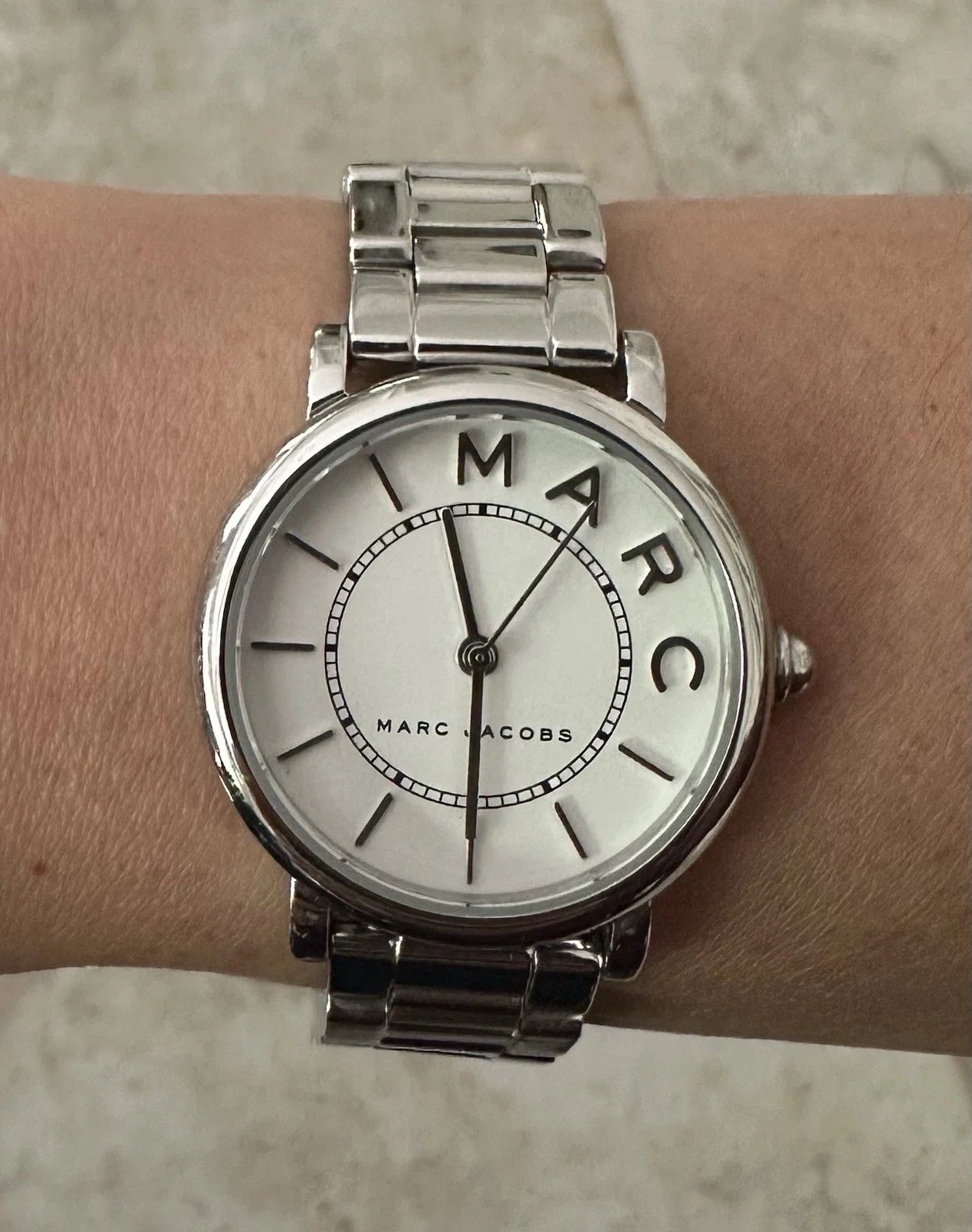 Marc Jacobs MJ3525 watch on wrist with silver stainless-steel bracelet and white dial