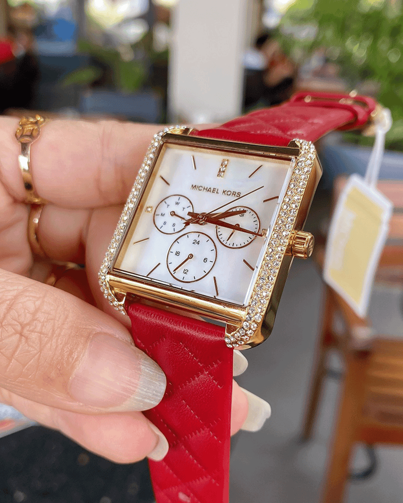 Michael Kors Pyper MK2770 watch worn on wrist with red leather strap and gold case