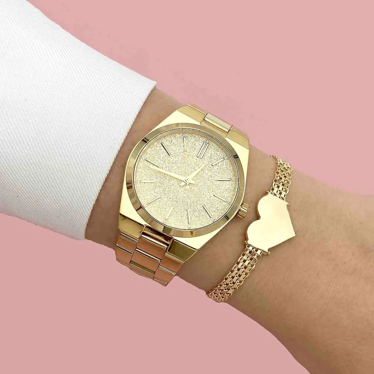 Michael Kors Channing MK6623 gold watch worn on wrist with gold accessories