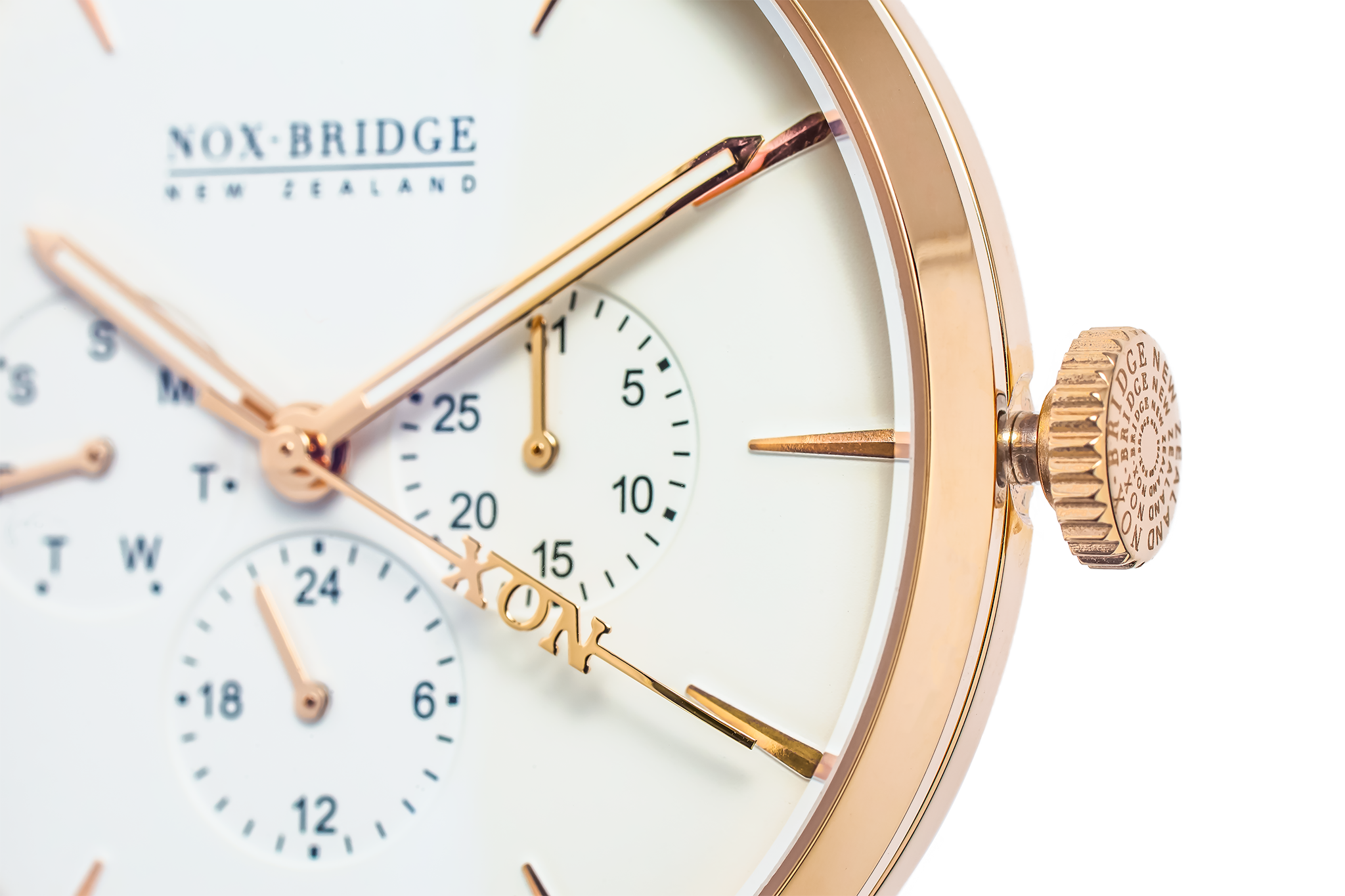 Close-up of rose gold case, cream dial with dual subdials, and crown detail