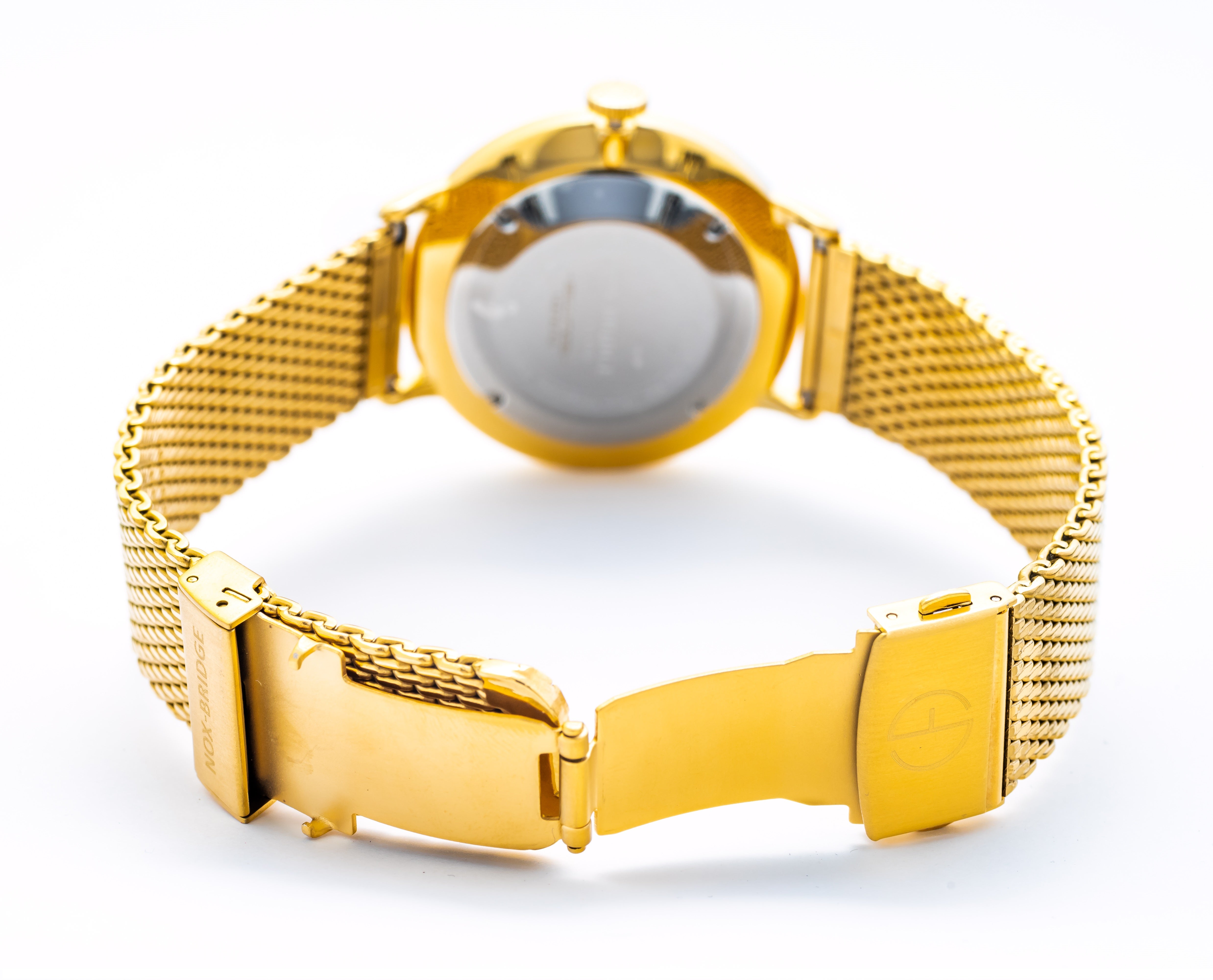 Noxbridge Vela watch on wrist with gold mesh bracelet and white dial