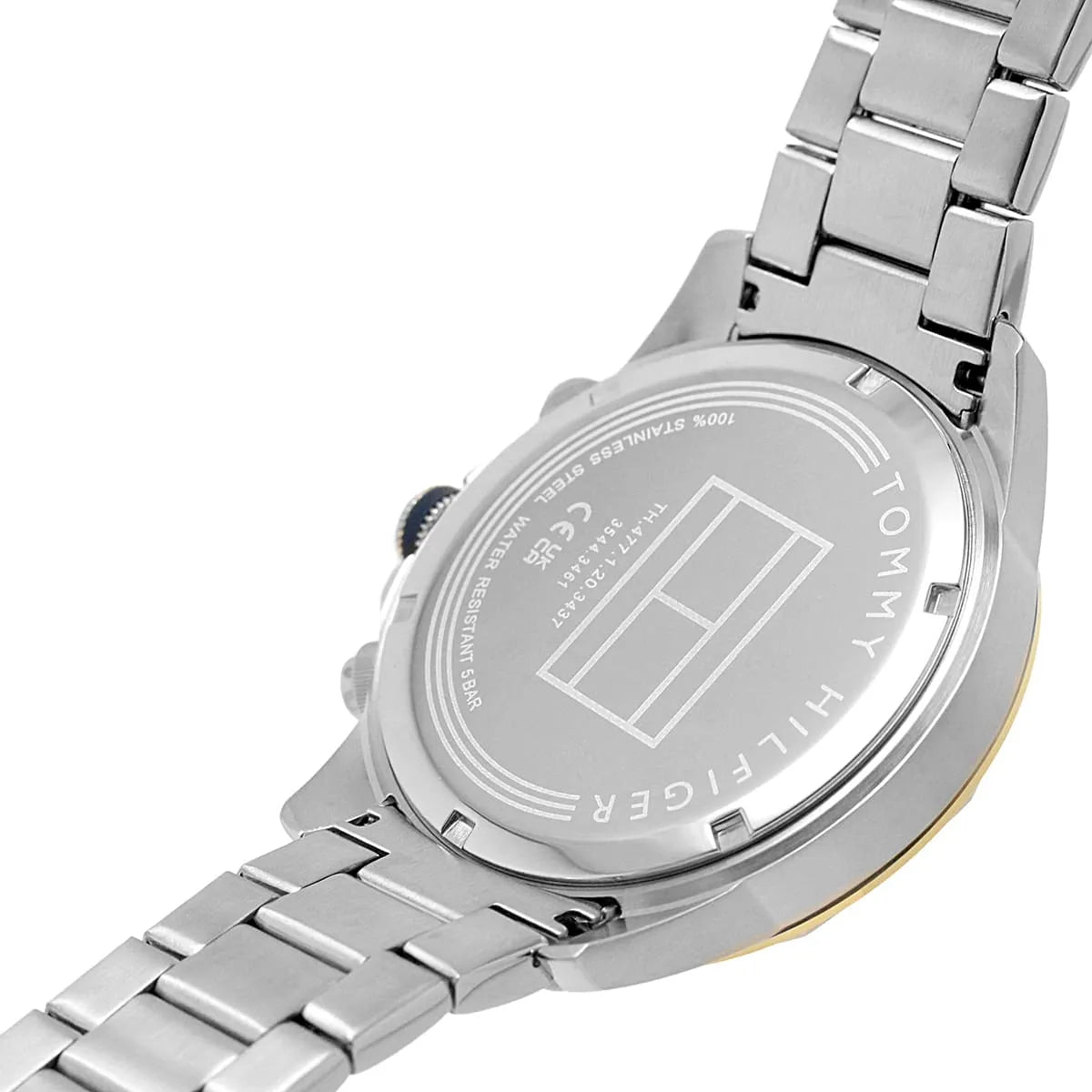 Case back of Tommy Hilfiger watch showing engraved specifications and stainless steel bracelet