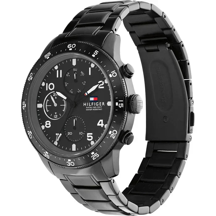 Tommy Hilfiger Jimmy watch at angle showing black chronograph dial and metal bracelet