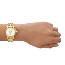 Tory Burch TBW1053 gold watch on wrist with beige dial and pattern