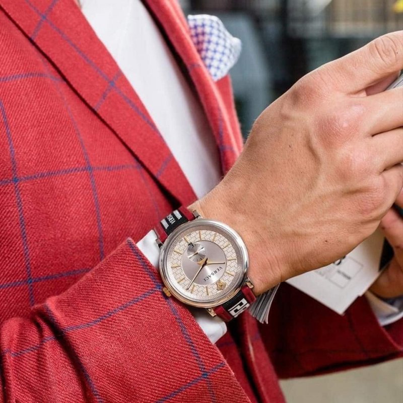Versace V Circle watch worn on wrist with red and navy plaid shirt
